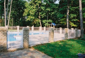 white aluminum fence with stone columns