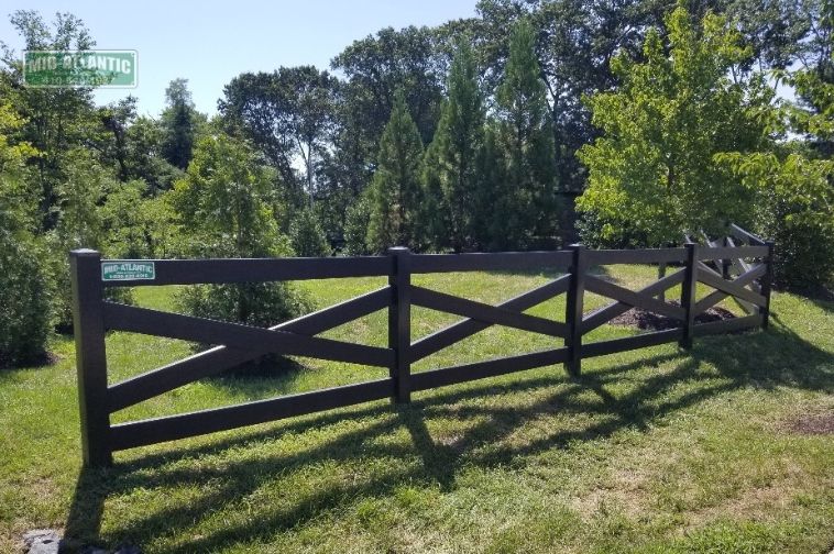 Black vinyl 4 rail estate style fence community entrance. Millersville Maryland.