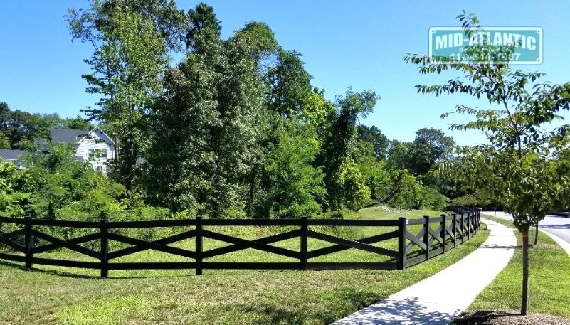 Black vinyl 4 rail estate style fence adds a nice touch to this walking trail in Millersville Maryland.