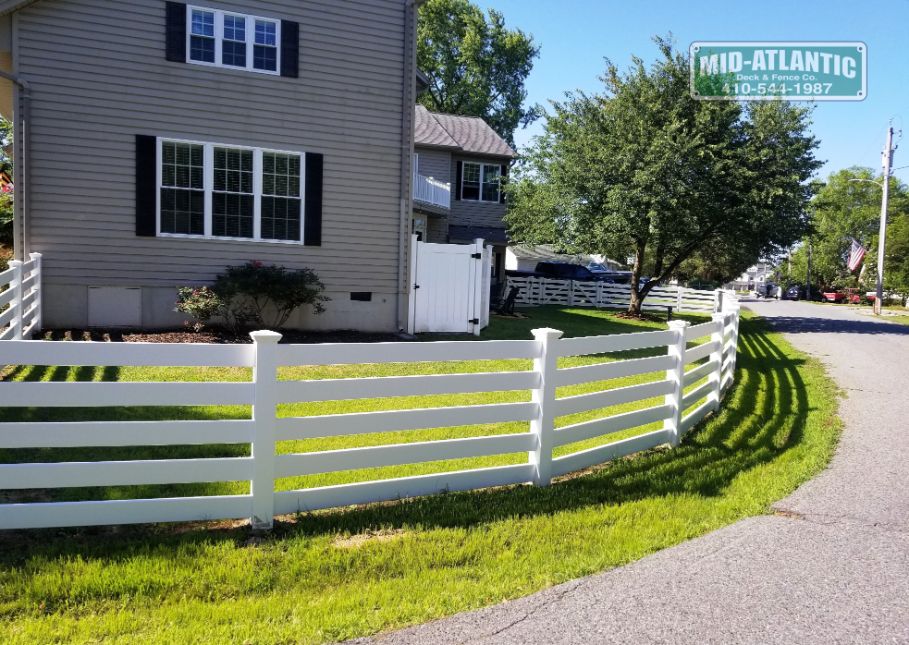 White vinyl 5 rail paddock style fence makes a nice added touch to this setting in Shadyside Maryland