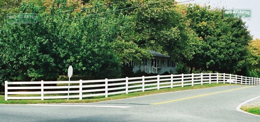 White vinyl 4 rail paddock style fence on the corner of Rt 2 and 255 in Harwood Maryland.
