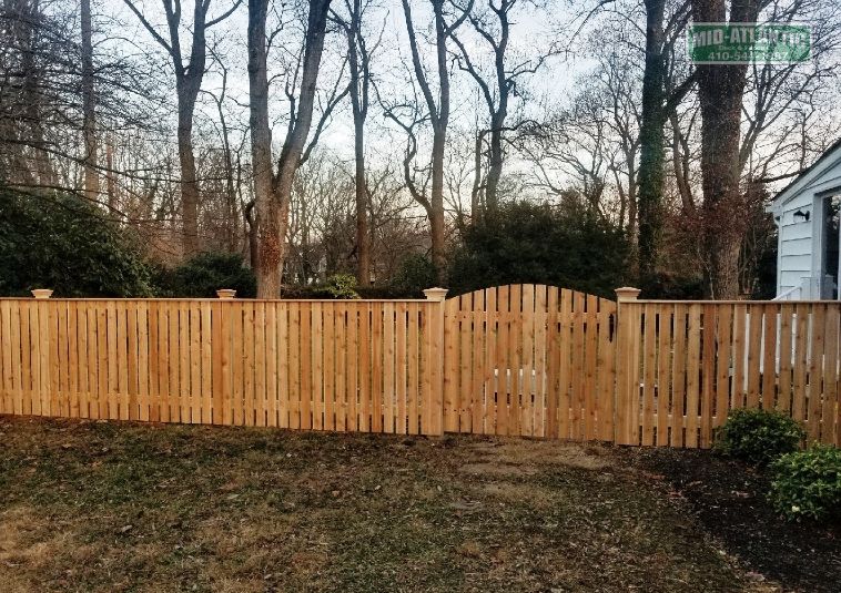 Customize your wood picket fence your way. This customer used cedar pickets with cedar cap board on top to finish it off. The arched picket style gate and cedar federal style wood post caps made a nice added touch. Located in Gingerville Maryland.