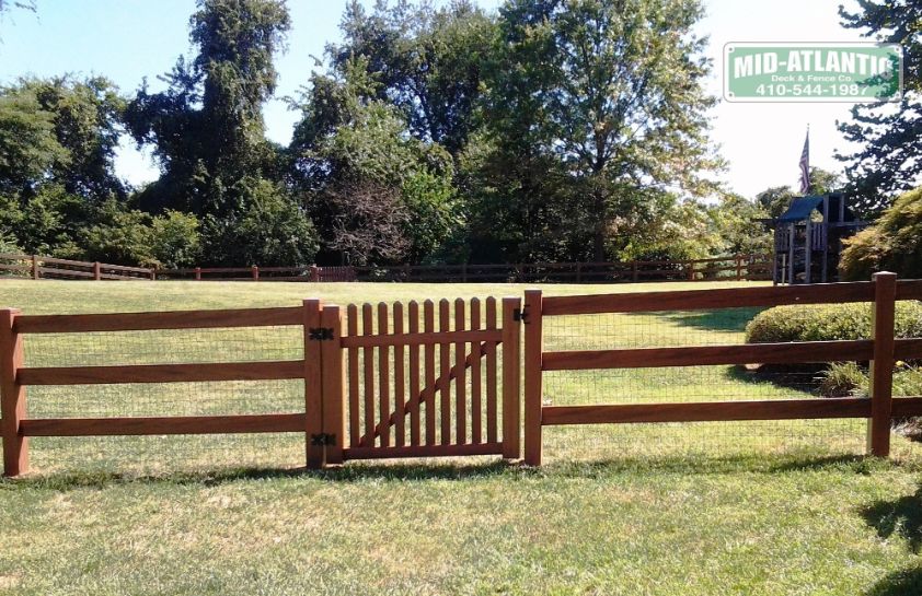 Vinyl 3 rail paddock style fence walnut color with convex top picket style gate.