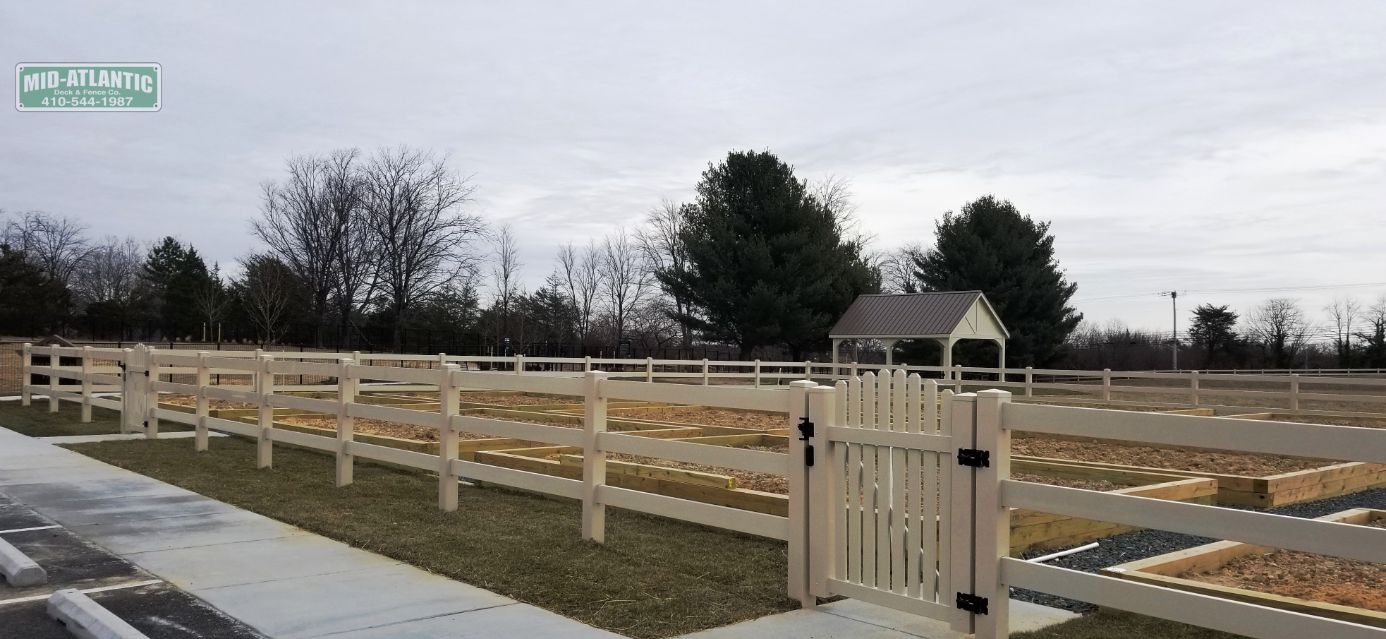 Tan vinyl 3 rail paddock style fence with convex top picket style gate. Hanover Maryland