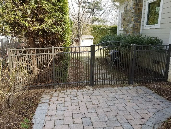 Bronze was the color of choice for this home. Add an arched top aluminum gate, really says welcome on this property.
