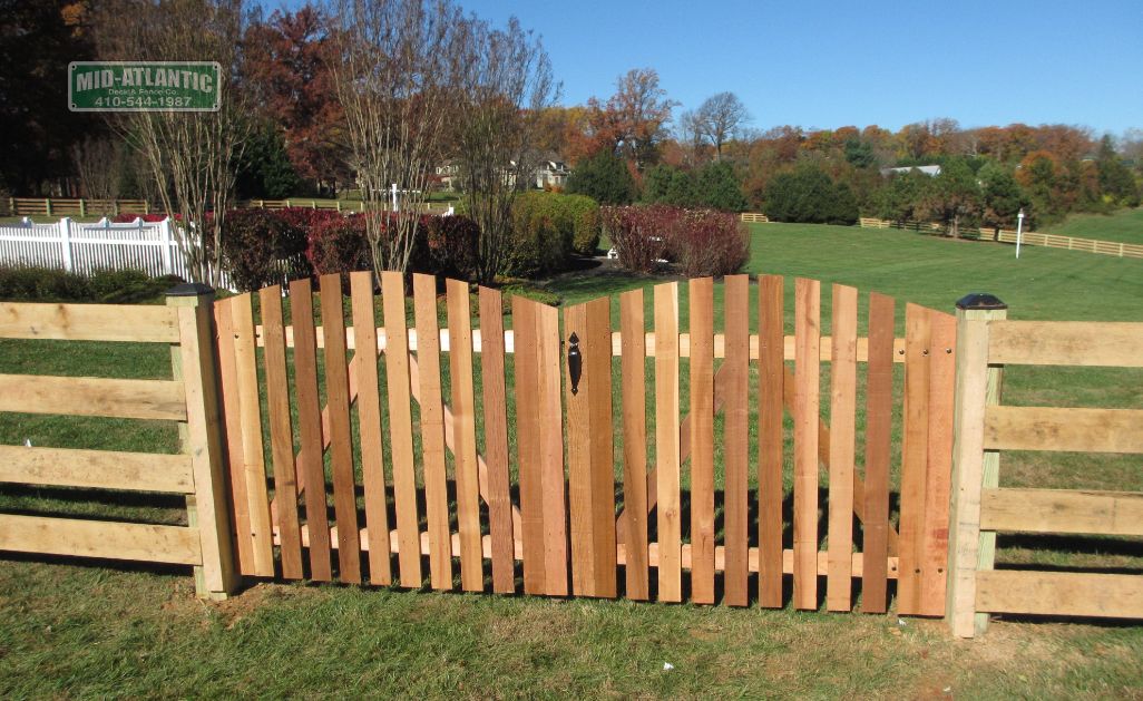 Here is a better shot of a wooden picket style arched top gate on a 3-rail paddock style fence in Clarksville Maryland.