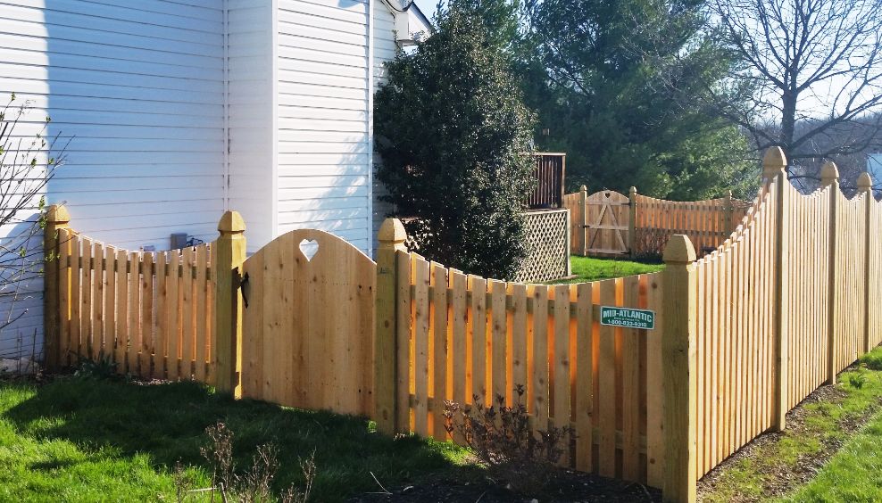The heart style gate really helped says welcome. Its 4’ tall in the front and gradually slopes up to 6’ tall on the sides and rear of the property. Great job on this Wyngate style fence with Mt Vernon dip.
