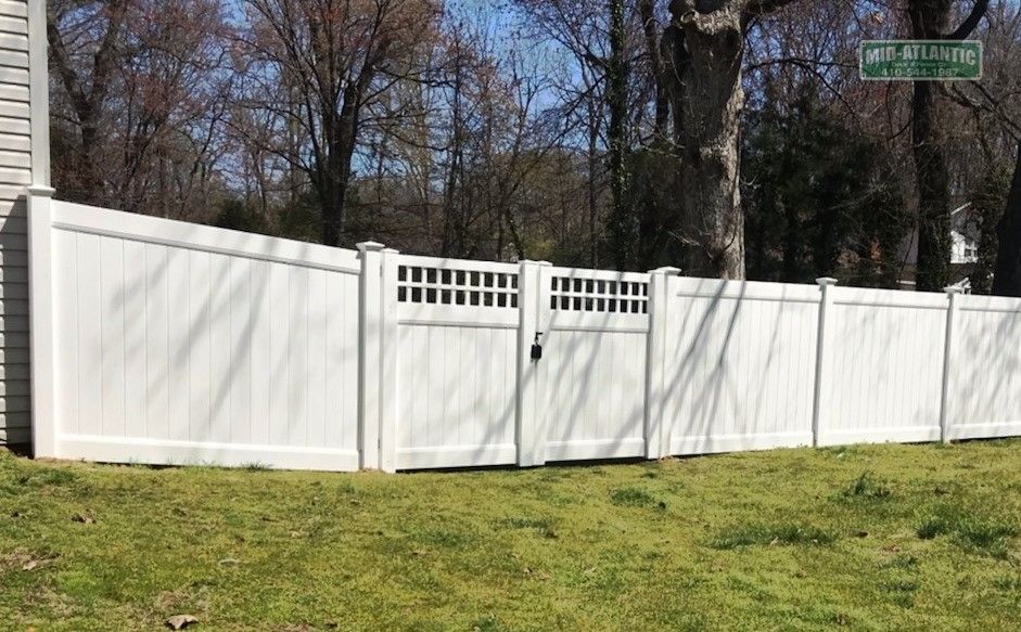 Custom square lattice top double drive gates are a nice added touch to any vinyl privacy fence. Manhattan beach Severna Park Maryland.