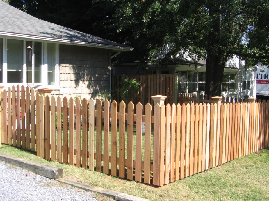 Like how the gate on this Pyramid picket style fence is a little higher and arched above the main fence. The federal style cedar post caps are a nice added touch.