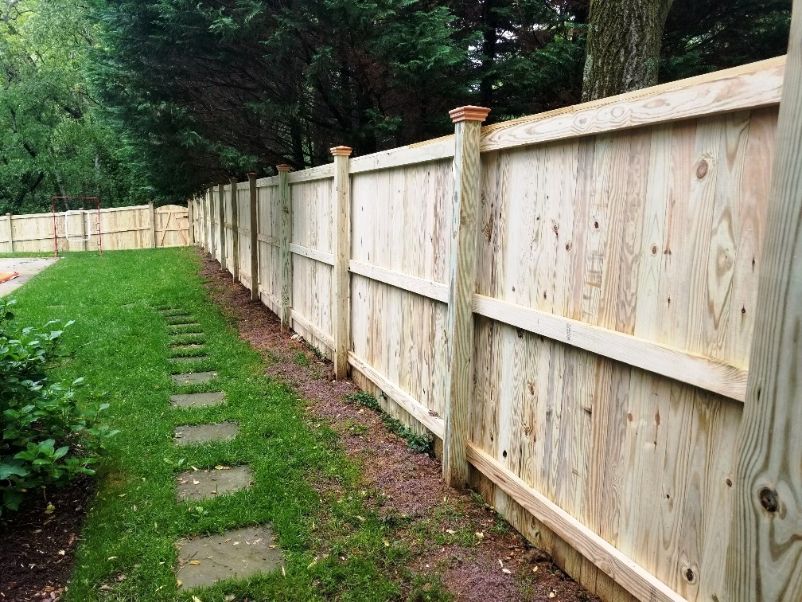 6’ tall pressure treated vertical board privacy fence located in the Poplar Ridge Community in Annapolis Maryland.