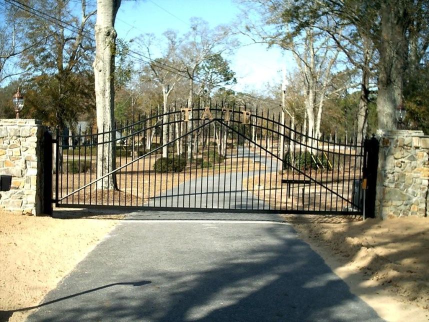 This is a big one. Love the oversized stone pillars and the continuous arched top ornamental steel gate really dresses up the entrance to this home.