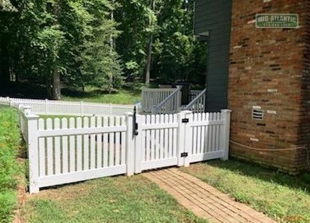 Notice the gate for this Standard white vinyl picket fence style. We used a top pull Magna latch for the gate latch to make it a little more difficult for the kids to escape. Severna Park Maryland.