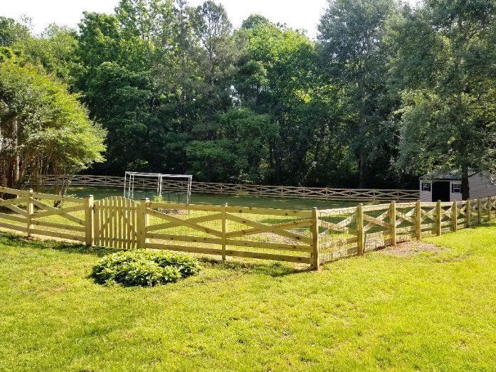 This homeowner made a great choice when the decided on this wood 5 rail estate style fence to define their property line and have a safe space for their family dog.