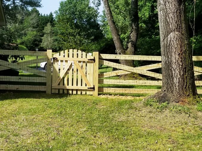 This is what the back side of a 5-rail estate wood fence looks like including the back side of the wood picket style gate with A frame brace.