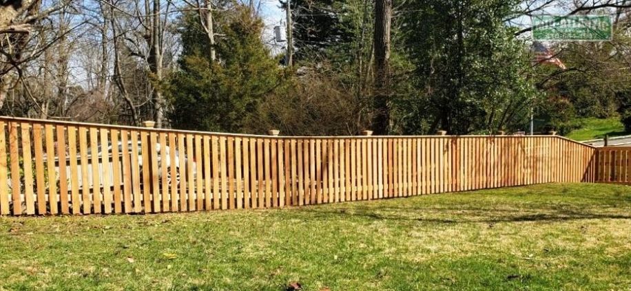 This flat top picket style fence in Arnold Maryland Rolls nicely with the changing grade.