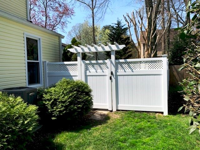 Here we go again. Chartridge white vinyl privacy fence with a custom flat top trellis over the gate in white. Montgomery county Maryland.