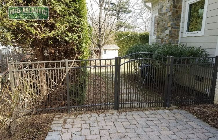 Add an arched top aluminum gate to define the entrance to your back yard.