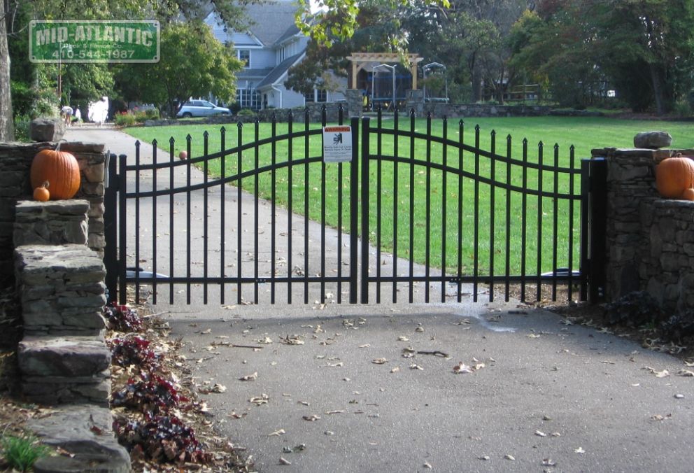 The pumpkin accents really make this steel ornamental arched top gate stand out for Halloween.