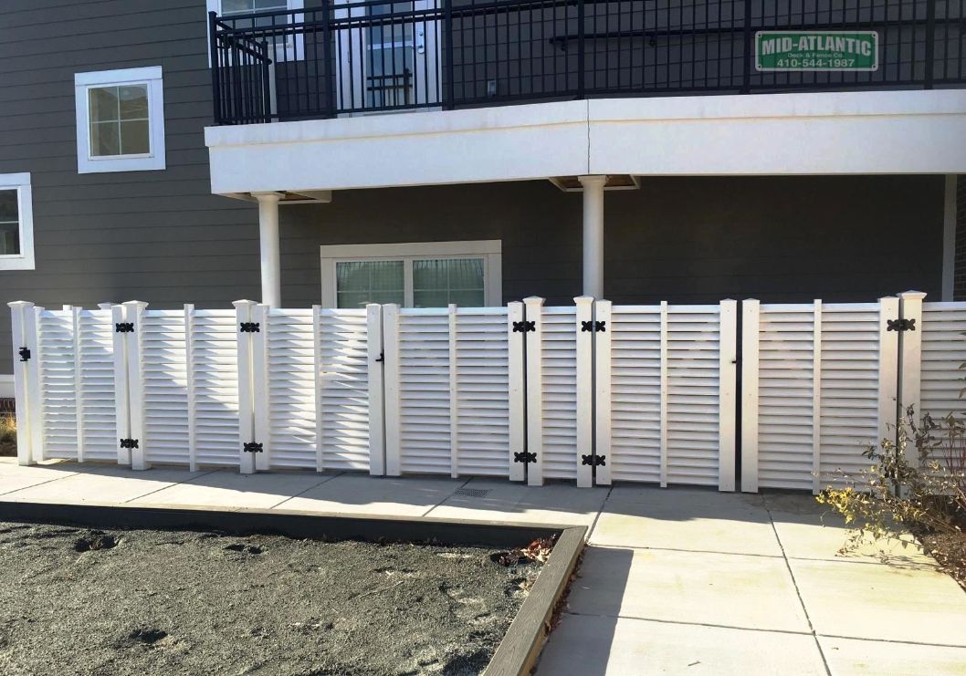 Totally custom louvered white viny semi-privacy fence that we designed and built for an apartment complex in Howard County.