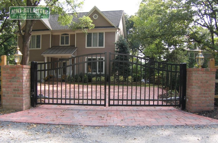 This is a 4 to 5’ tall estate style gate installed in between brick pillars with a automatic gate operator.