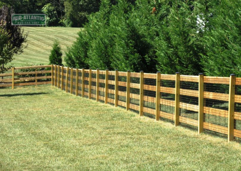 3 Rails isn’t enough this customer in Burtonsville Maryland added a 4th rail to this paddock style wood fence to keep his family dog safely contained in his yard.
