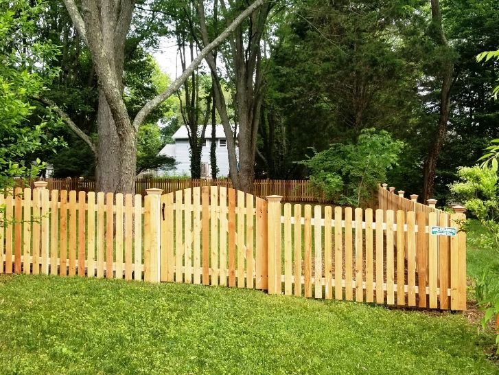 Because we stick build all our fences on site. Allows us to run this dog-eared cedar wood picket fence on this sloping grade in Bowie Maryland.