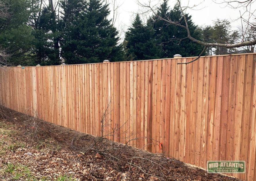 We build 8’ tall privacy fences. This is our board and batten style privacy fence with 6x6 posts and standard black post caps. A big shout out to our installation team.