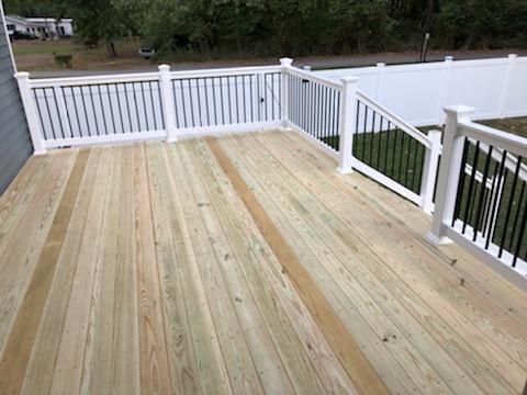 Pressure treated decking in Crofton Maryland. Complete with White viny railings and black aluminum balusters.