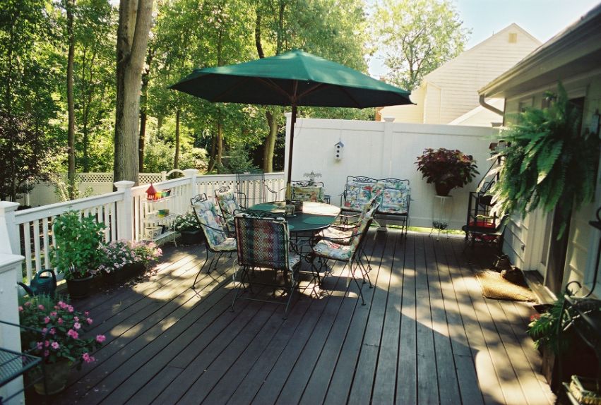 deck in shade with umbrella-covered dining set
