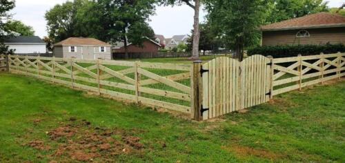Notice the arched top picket style fence. they are a great accent to this 5-rail estatestyle fence in Davidsonville Maryland.