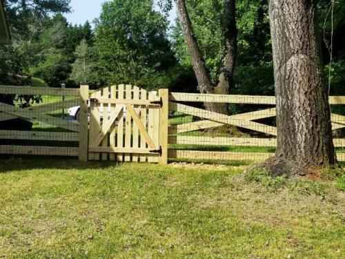 This is what the back side of a 5-rail estate wood fence looks like including the back sideof the wood picket style gate with A frame brace.