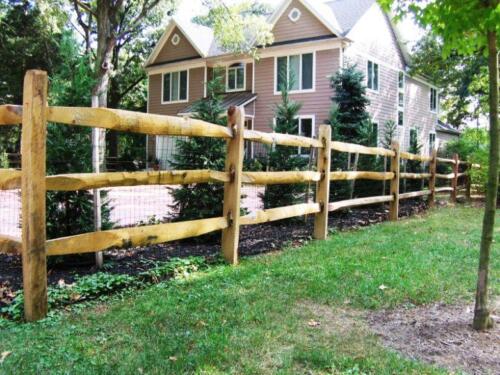 A wood split rail fence is an excellent choice when you are looking for a nice back dropfor plant scaping at this Severna Park Maryland home.