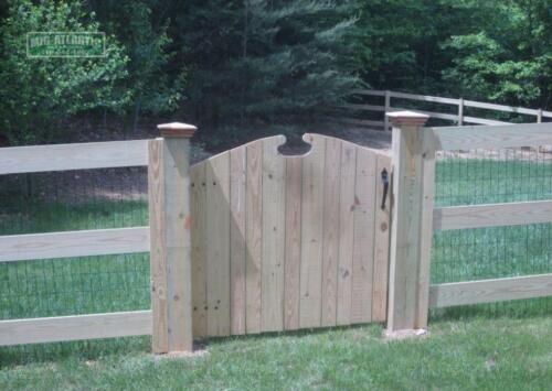 3-Rail paddock style wood fence with a picket style arched top double drive gate inClarksville Howard County Maryland.